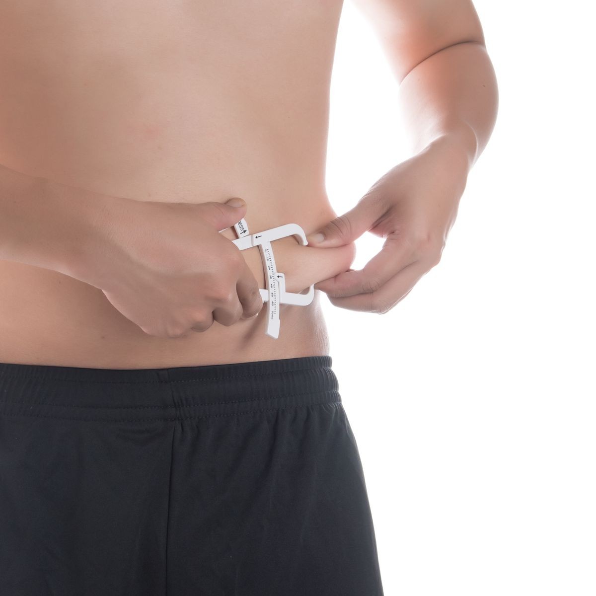 Man is measuring his body fat with calipers,healthy lifestyle and body care concept.
