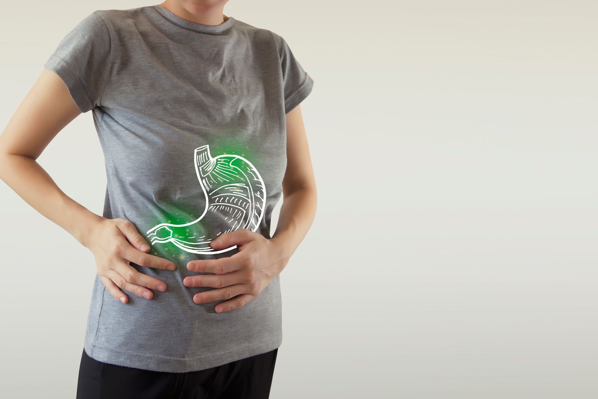 Digital composite of highlighted green  stomach of woman with infection